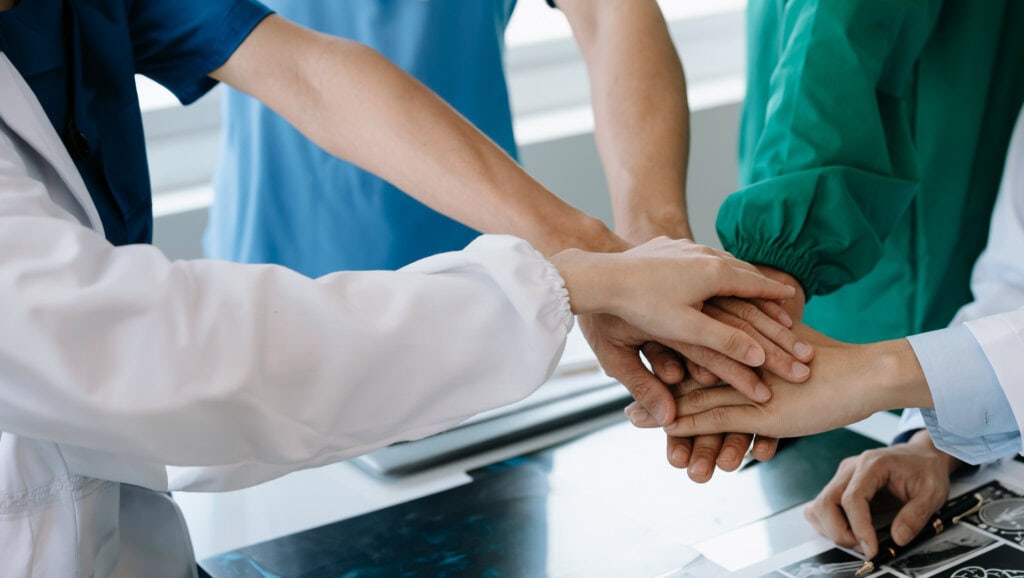Team Doctors nurses union coordinate hands Teamwork Concept in hospital for success and trust in the team.